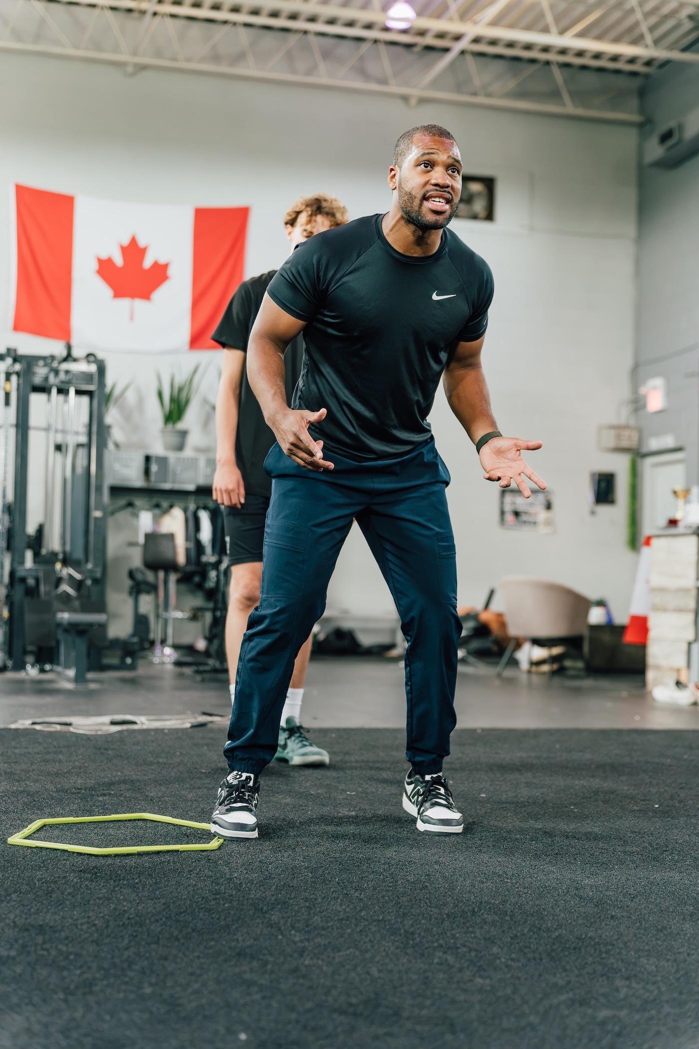 Coach demonstrating proper form during a training session